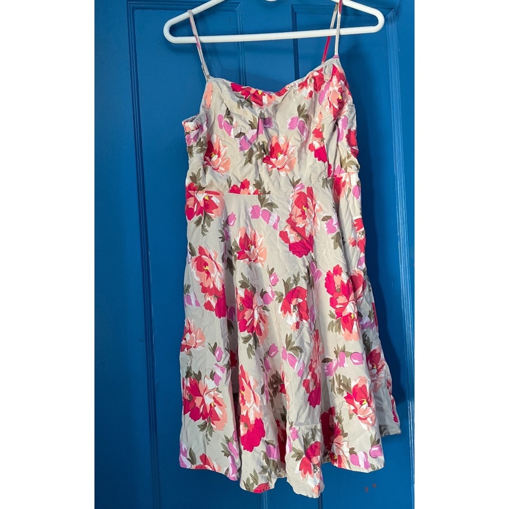 Beige dress with flower patterns on it and nice to wear for a Hot day